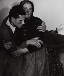 Woman supporting a sickly man at a displaced persons camp in Austria